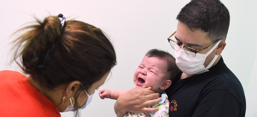 Adrian Perez looks on while a nurse administers a dose of the Moderna Covid-19 vaccine to his 6-month-old son at Nona Pediatric Center in Orlando, June 24, 2022. On June 18, the Centers for Disease Control and Prevention (CDC) recommended that all children six months to 5 years of age can receive a COVID-19 vaccine. Florida Gov. Ron DeSantis has refused to order vaccine doses for state health departments, making Florida the only state not providing the vaccine for young kids.