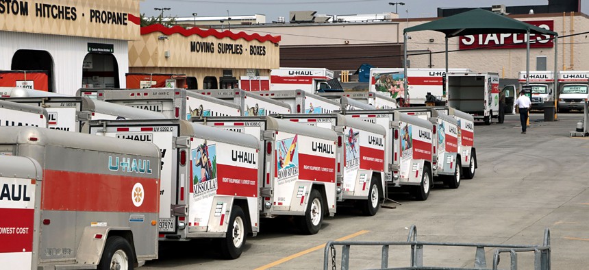 U-Haul trailers lined up on lot ready for rental. 