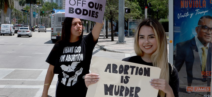 Amanda Guerra, right, holds a sign reading, 'Abortion is Murder,' as she counter-protests during a rally supporting the right for abortions to be protected by the federal government on May 3, 2022 in Miami. 