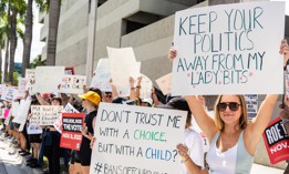 An abortion rights activist holds a sign at a protest in support of abortion access on July 13, 2022 in Fort Lauderdale.