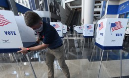 Workers set up voting booths six feet apart for social distancing at an early voting site established by the City of Orlando and the Orlando Magic at the Amway Center, the home arena of the Magic, on October 15, 2020 in Orlando.