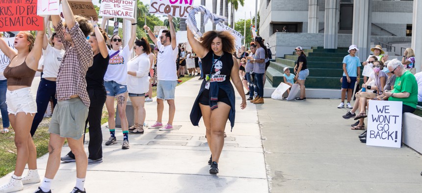 An abortion rights activist holds a sign at a protest in support of abortion accessnon July 13, 2022 in Fort Lauderdale.