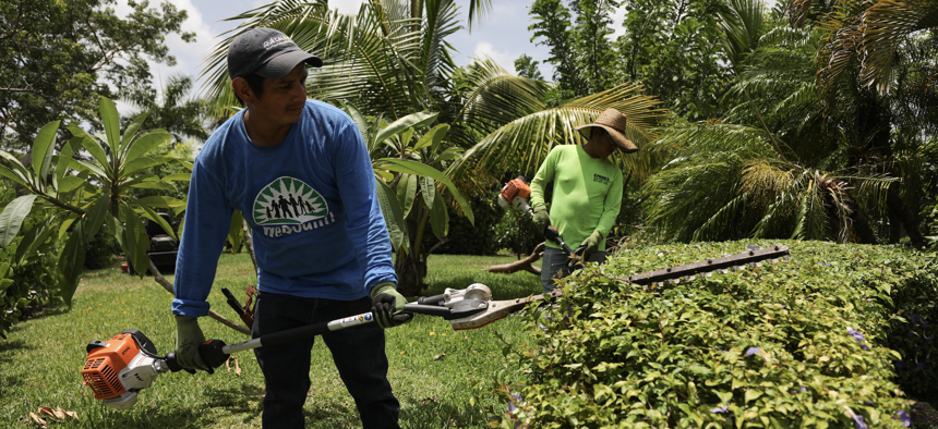 Homestead, Florida landscaper Carlos Morales (foreground), seen at work on Aug. 1. Florida is ranked 29th among the states in working conditions, according to a new report. 