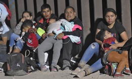 Migrants attempting to cross in to the U.S. from Mexico are detained by U.S. Customs and Border Protection at the border August 20, 2022 in San Luis, Arizona.