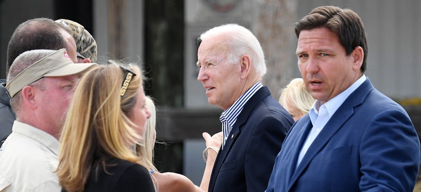 Florida Gov. Ron DeSantis and President Joe Biden speak with local residents affected by Hurricane Ian at Fishermans Pass in Fort Myers, Oct. 5, 2022.