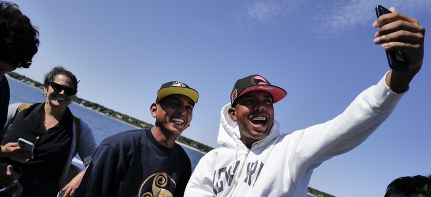 Martha's Vineyard, MA (Sept. 16, 2022) - Rafael, right, takes a selfie with another Venezuelan migrant on a ferry to Woods Hole, Massachusetts. The group was transported from Martha's Vineyard to Joint Base Cape Cod in Buzzards Bay. 