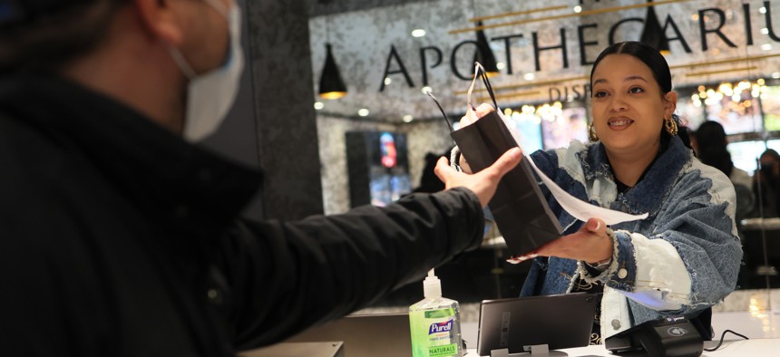 A customer receives their order from an employee at Apothecarium Dispensary on April 21, 2022 in Maplewood, New Jersey, where voters approved legalization in November 2020. 