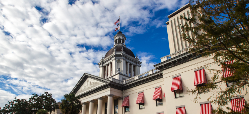 A view of the old Capitol in Tallahassee, with the top of the new Capitol visible, upper right. 
