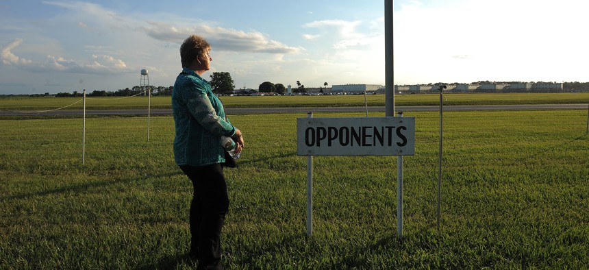 Britta Slopianka stands by herself, in the section outside Florida State Prison reserved for opponents of the death penalty, before the execution of John Ruthell Henry, June 18, 2014, in Raiford. 