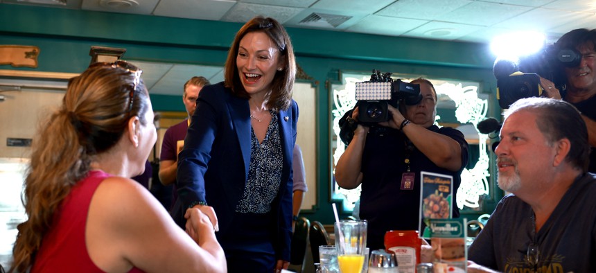 Then-Agriculture Commissioner and Democratic candidate for governor Nikki Fried greets people as she visits the Versaille restaurant on Aug. 22, 2022 in Miami. 