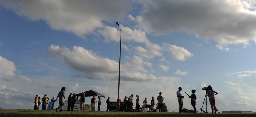 People opposed to the death penalty and media members are seen near the Florida State Prison on Wednesday June 18, 2014 in Raiford.