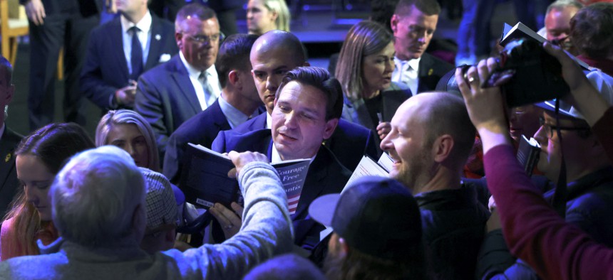 DeSantis signs autographs after speaking to Iowa voters during an event at the Iowa State Fairgrounds on March 10, 2023 in Des Moines, Iowa. DeSantis, who is widely expected to seek the 2024 Republican nomination for president, is one of several Republican leaders visiting the state this month. 