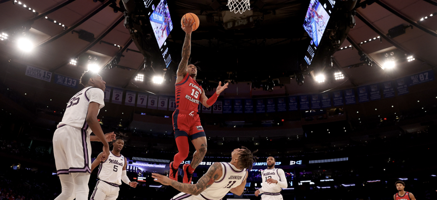 Alijah Martin #15 of the Florida Atlantic Owls drives against Markquis Nowell #1 of the Kansas State Wildcats during the Elite Eight round of the 2023 NCAA Men's Basketball Tournament held at Madison Square Garden on March 25, 2023 in New York City.