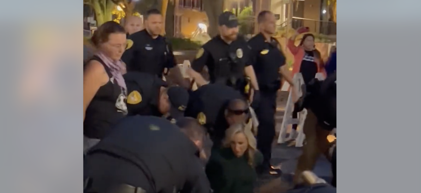 Video capture showing Florida Senate Democratic Leader Lauren Book being arrested outside Tallahassee City Hall. 