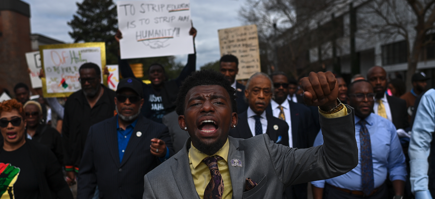 Demonstrators protest DeSantis’ plan to eliminate Advanced Placement courses on African American studies in high schools as they march to the Florida Capitol, Feb. 15, 2023. 