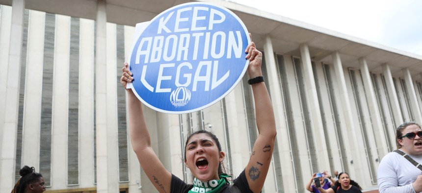 A protester outside the Florida Capitol where lawmakers were considering the now-passed 6-week abortion ban, April 3, 2023.