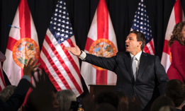 Florida Gov. Ron DeSantis throws pens into the crowd after signing a series of education bills at Cambridge Christian school in Tampa, Fla. on Wednesday, May 17, 2023.