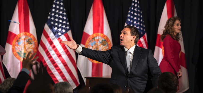 Florida Gov. Ron DeSantis throws pens into the crowd after signing a series of education bills at Cambridge Christian school in Tampa, Fla. on Wednesday, May 17, 2023.