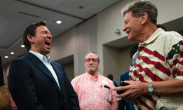 DeSantis (at left) speaks with attendees during an Iowa GOP reception on May 13, 2023 in Cedar Rapids, Iowa. 