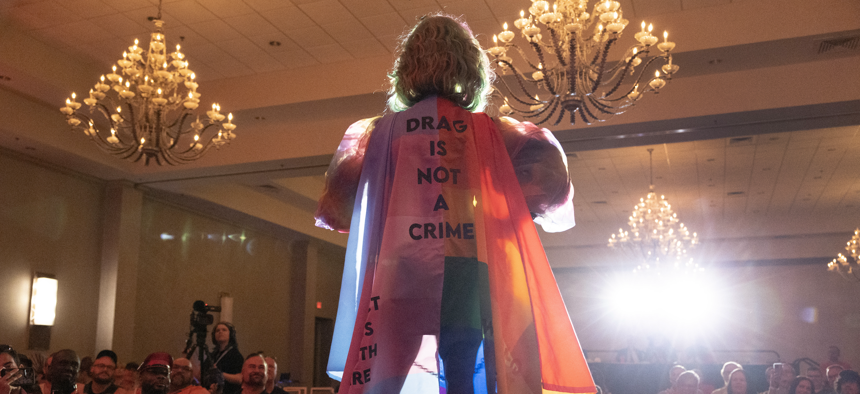 Salem Sanderson wears a cape that reads "Drag is Not a Crime" while performing during the Miss Gay Days Pageant at the DoubleTree by Hilton Orlando at SeaWorld on June 3, 2023 in Orlando. As Florida Gov. Ron DeSantis and Florida lawmakers passed anti-LGBTQ laws, Gay Days organizers encouraged visitors to continue to attend one of Florida’s largest gay and lesbian celebrations. 
