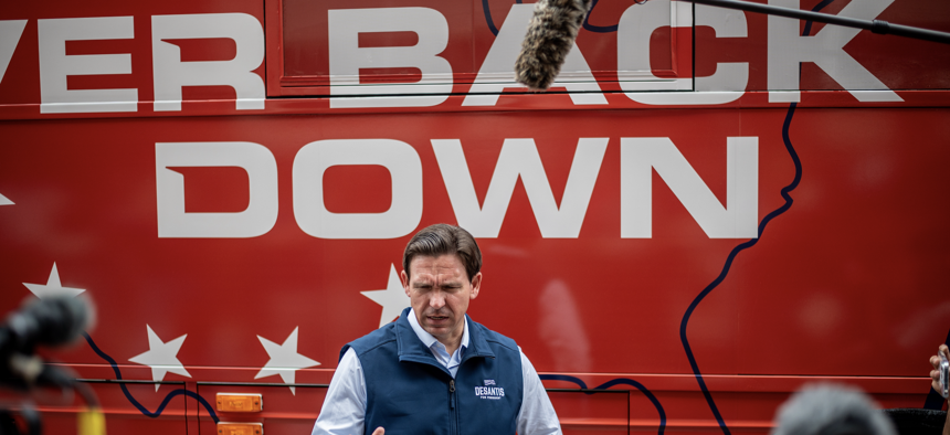 DeSantis speaks to news media after an event on Thursday, July 27, 2023 in Chariton, Iowa, in front of the Never Back Down super PAC bus. 