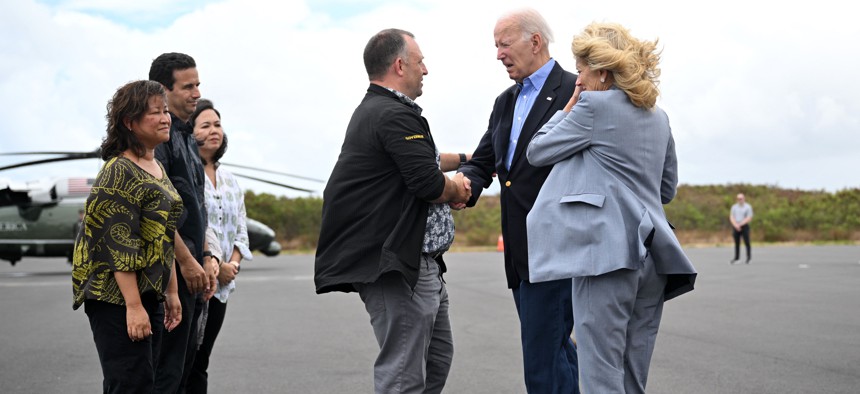 President Joe Biden and First Lady Jill Biden greet Hawaii Governor Josh Green (at center) upon arrival at Kahului Airport in Kahului, Hawaii, Aug. 21, 2023. The Bidens are expected to meet with first responders, survivors, and local officials following deadly wildfires in Maui. 