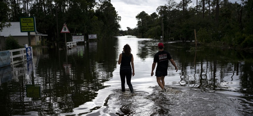 People survey the damage and flooding in Steinhatchee on Wednesday, Aug. 30, 2023, after Hurricane Idalia passed through.