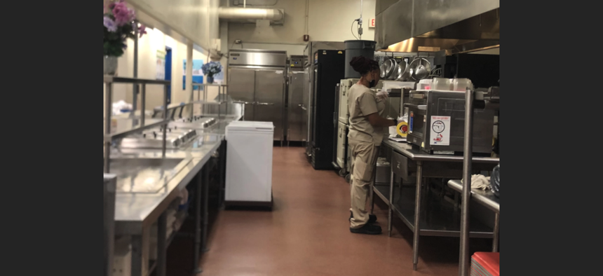 A food service employee works in the school cafeteria at Edison Park K-8 Center in Miami.