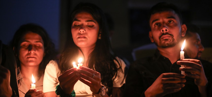Nepali students hold a candlelight vigil for those fallen in Israel from the Hamas attacks on Oct. 7, 2023. 