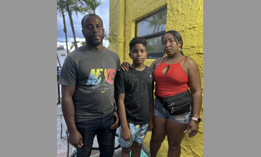 Thirteen-year-old Wistong and his parents made the treacherous journey from their home in Venezuela up through the Darién Gap and Central America to reach the U.S.-Mexico border on foot. They posed outside their Miami apartment on Sept. 14, 2023. 